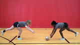 Athletes performing Partner Hip Hinge Ball Roll exercise