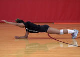 Athlete performing front plank with arm lifts exercise