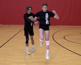 Athlete performing jumps with partner bumps exercise with a single-leg landing