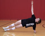 Athlete performing side plank torso rotation exercise from foot support