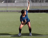 Athlete performing a squat hold with torso rotation