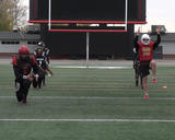 Football athletes performing walking lunges with torso rotation, leg, and arm lifts
