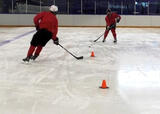 Hockey players performing a figure 8 passing drill on a hockey rink