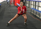 Athlete performing lateral lunge exercise in an ice hockey arena