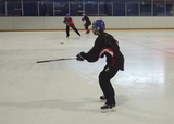 Ringette players performing a 3-player weave drill on-ice