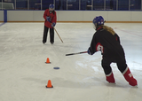 Ringette players performing a figure 8 passing drill on ice
