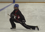 Ringette player performing lunges with rotation on ice