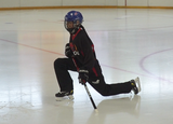 Ringette player performing lunges on ice