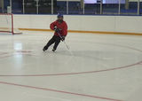 Ringette players performing a zig-zag horseshoe drill on ice