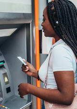 woman standing at a bank machine