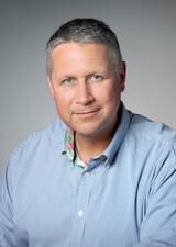 A portrait photograph of Bruce Evelyn