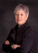 A portrait photography of Penny Werthner crossing her arms across her chest