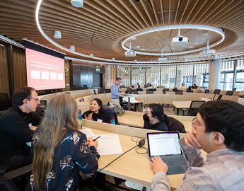 People gathered in the Viewpoint Circle room in Mathison Hall, engaging in a Strategic Planning Workshop.