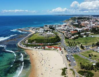 Newcastle beach aerial view with blue skies above