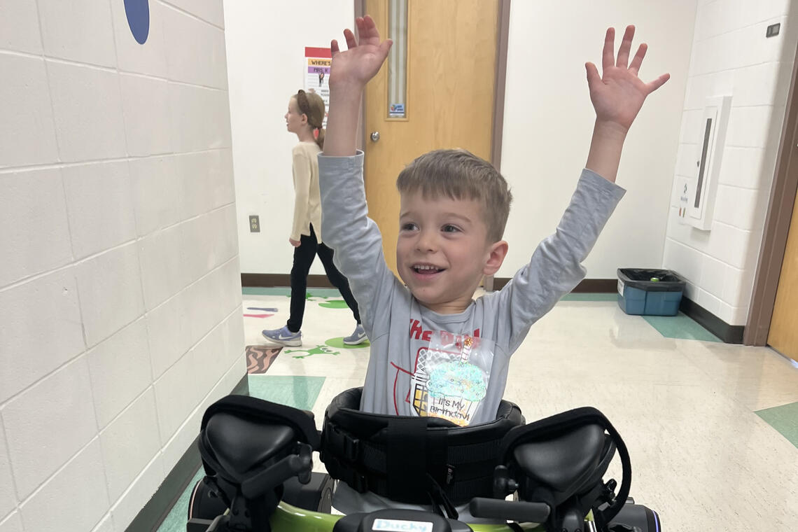 A small boy in a hospital hallway