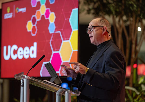 A man stands behind a podium